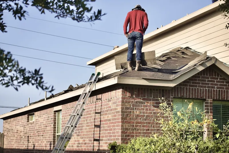 Professional roofer working on a residential roof in Pacific-Edison